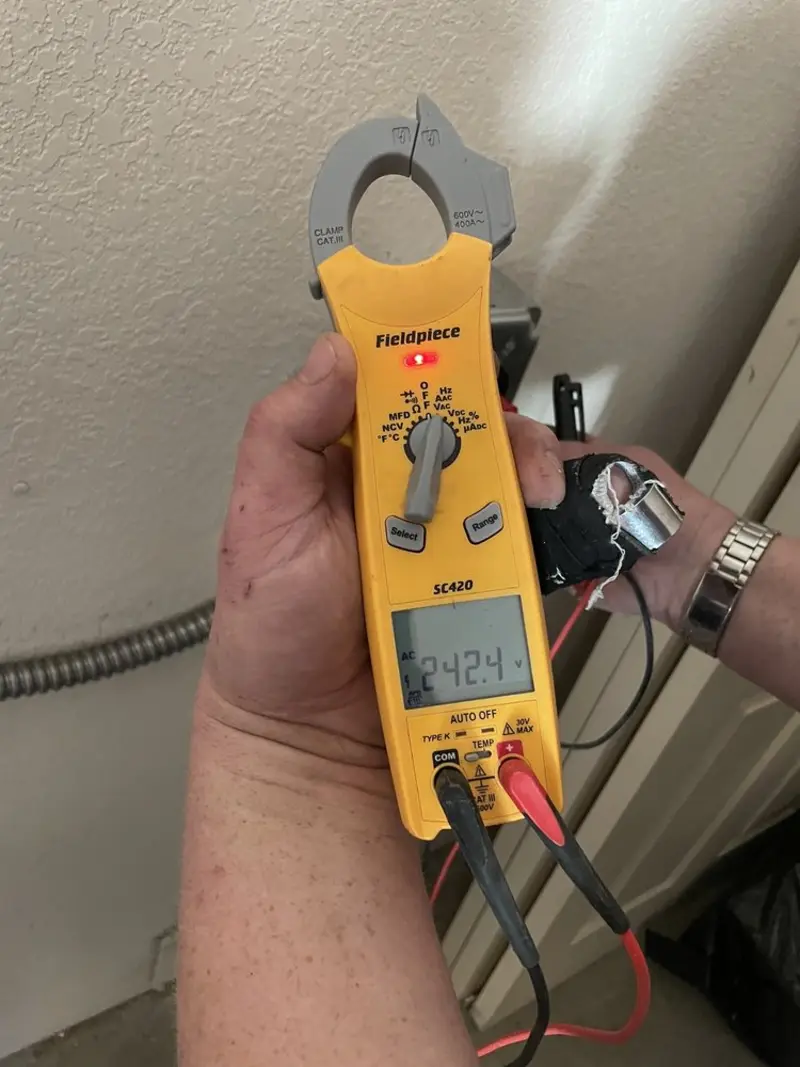 Voltage testing with clamp meter during Recessed Lighting Installation in Newburgh